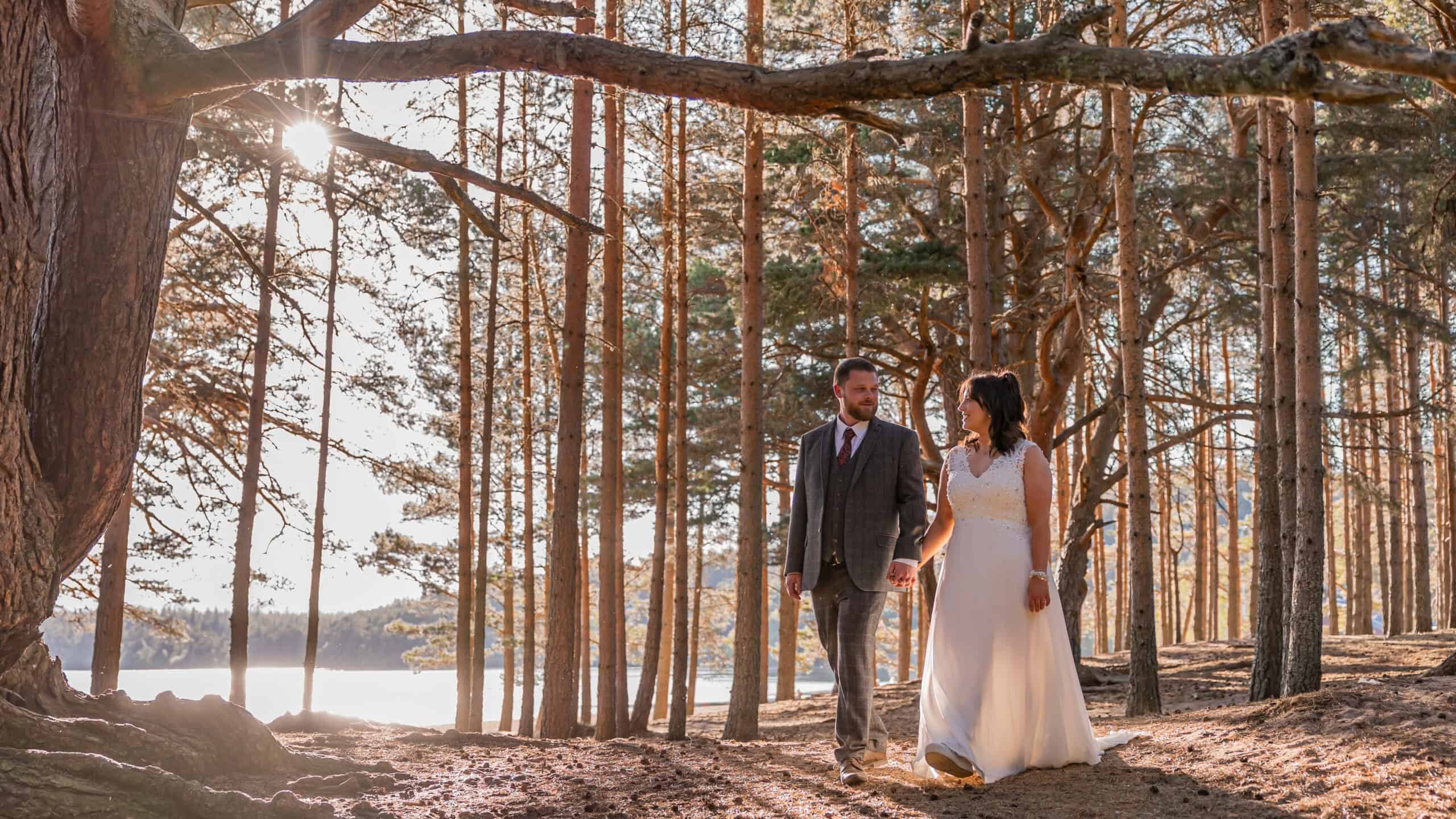 Newlyweds walking in sunny forest