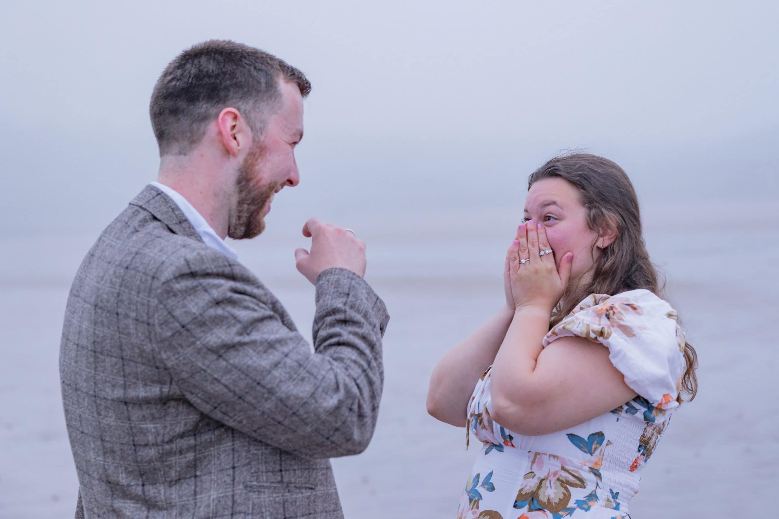 Surprised couple on a foggy beach scene.