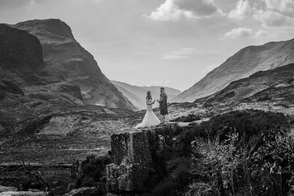 Bride and groom on rocky mountain landscape