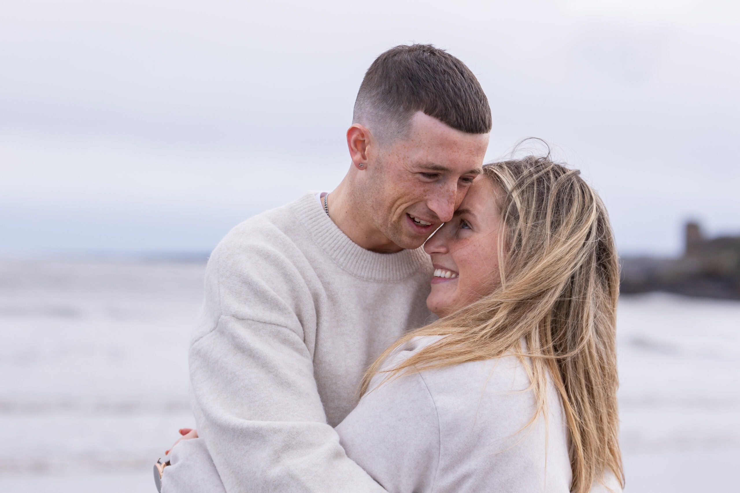 Couple embracing on a beach.