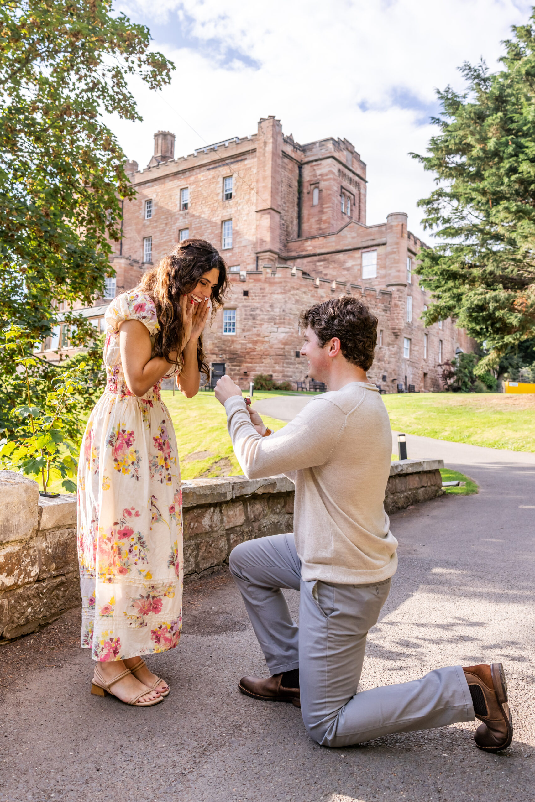 Man proposes outside a historic castle