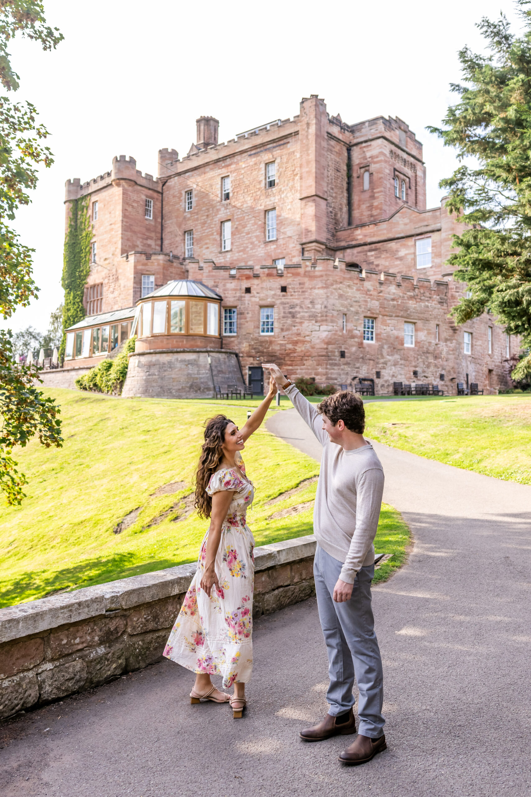 Couple dancing outside a historic sandstone castle