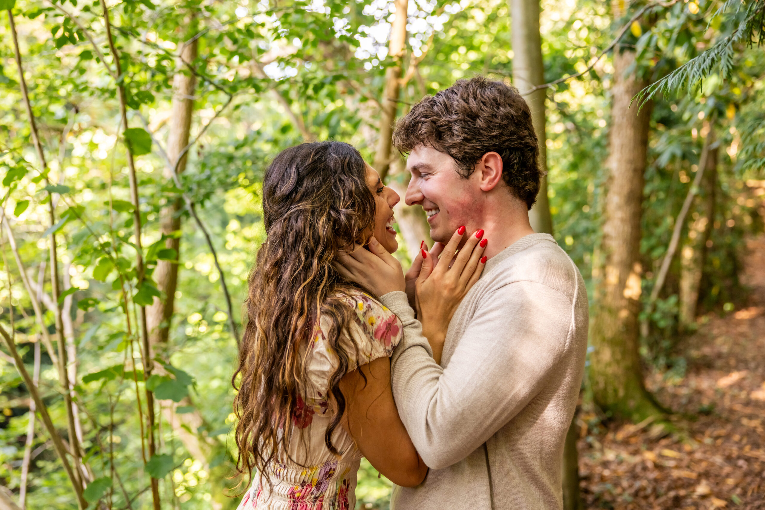 Smiling couple embrace in the grounds of Dalhousie Castle