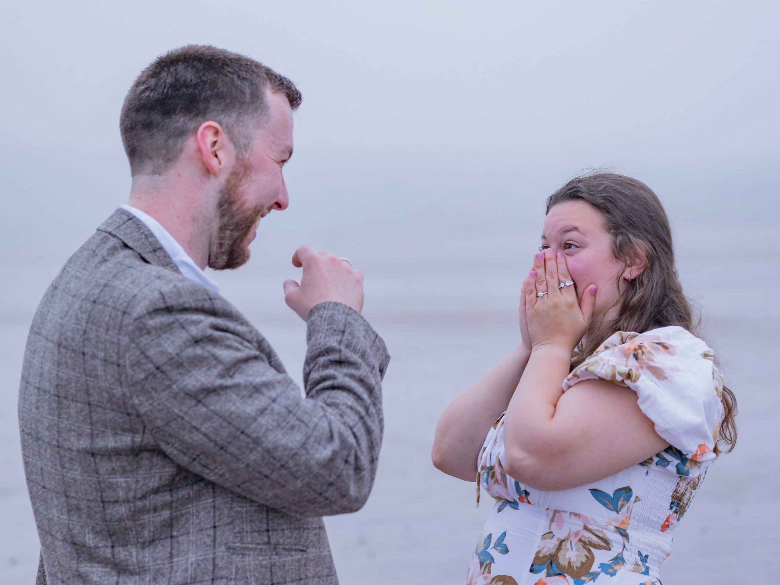 Surprised couple on a foggy beach scene.